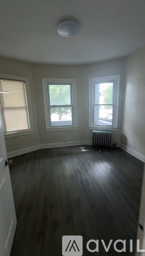 A room with a window and a radiator on the wall.