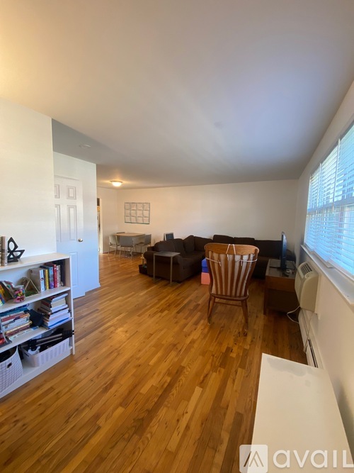 A living room with wooden floors and furniture.
