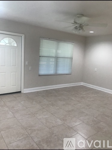 A room with a tiled floor and a ceiling fan.