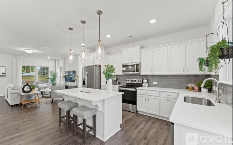 A modern kitchen with white cabinets and a large island.