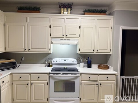 A white kitchen with a stove and oven.