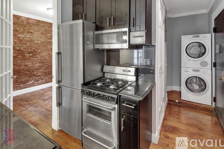 A kitchen with a stove top oven and a microwave above it.