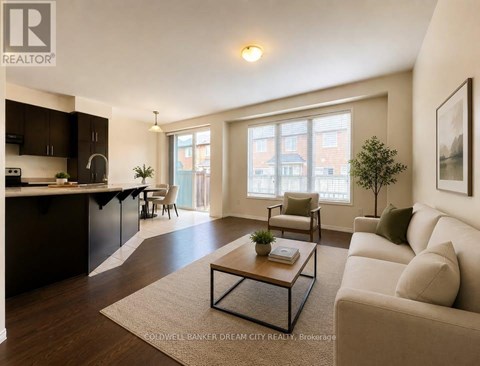 A well-lit living room with a beige sofa and a coffee table.