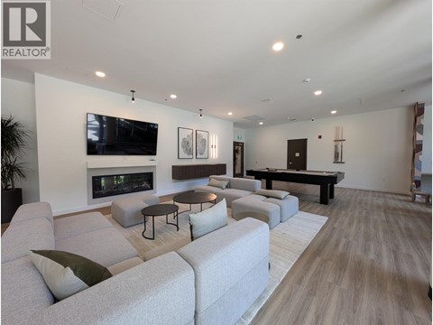 A living room with a fireplace and a television mounted on the wall.