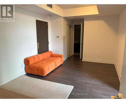 A living room with a couch and a rug.