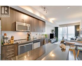 A modern kitchen with wooden cabinets and stainless steel appliances.