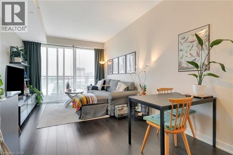 A living room with a grey couch and a wooden table.