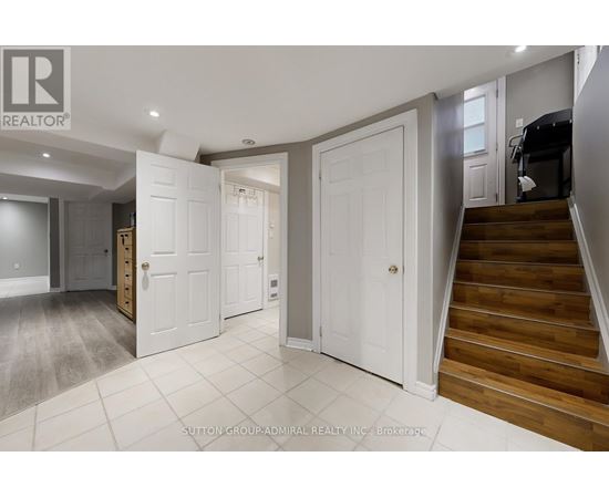 A hallway with a staircase leading to the second floor.