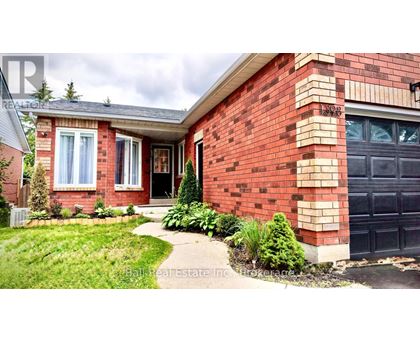 A red brick house with a black garage door and a white window.