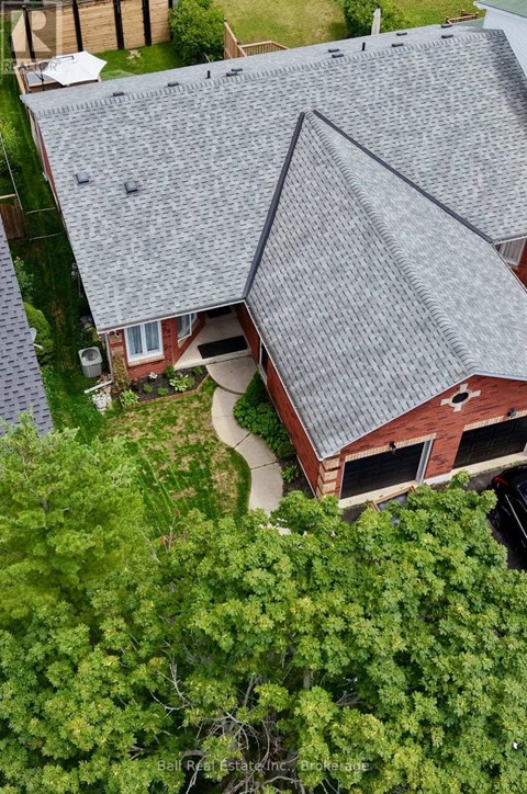 A house with a grey roof surrounded by trees.