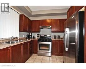 A kitchen with wooden cabinets and stainless steel appliances.
