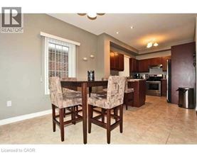 A dining room with a table and chairs.