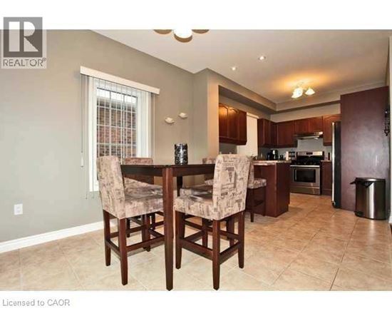 A dining room with a table and chairs.