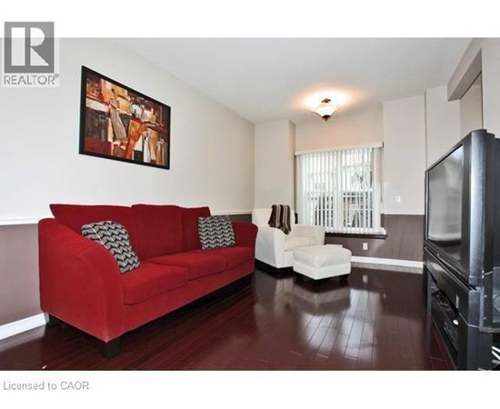 A living room with a red couch and a television.
