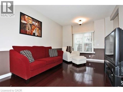 A living room with a red couch and a television.
