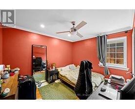 A bedroom with a bed, desk, and chair.