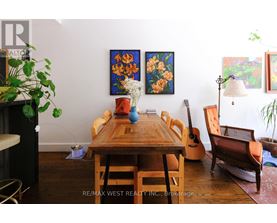 A dining room with a wooden table and chairs.