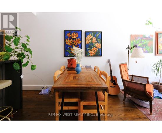 A dining room with a wooden table and chairs.