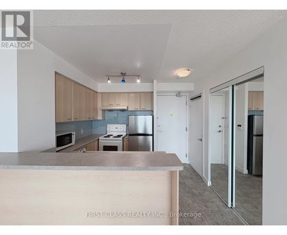 A kitchen with a counter top and cabinets.