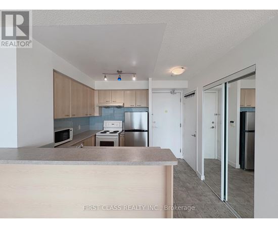 A kitchen with a counter top and cabinets.