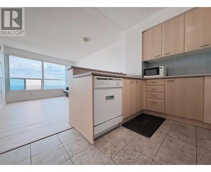 A kitchen with a dishwasher, microwave, and oven.