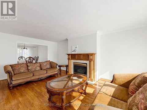A living room with a brown couch and a fireplace.