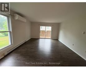 A room with a sliding door leading to a balcony.