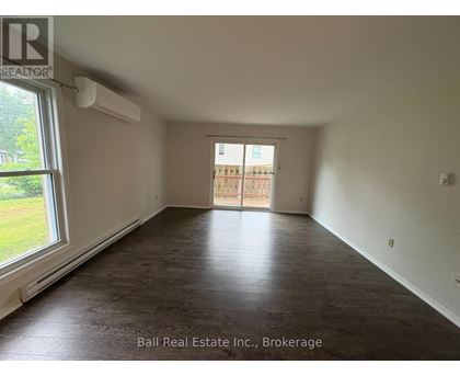 A room with a sliding door leading to a balcony.