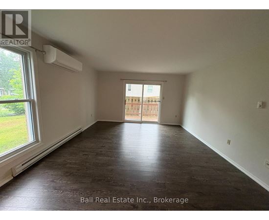 A room with a sliding door leading to a balcony.
