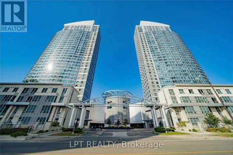 Two modern glass buildings with a white entrance in front.