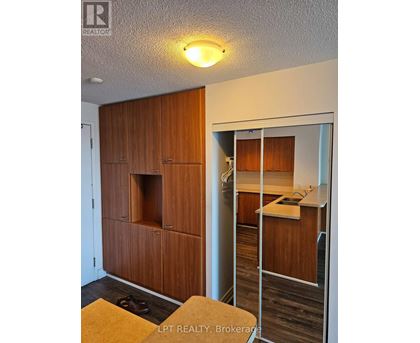 A wooden cabinet with a glass door is in the foreground.
