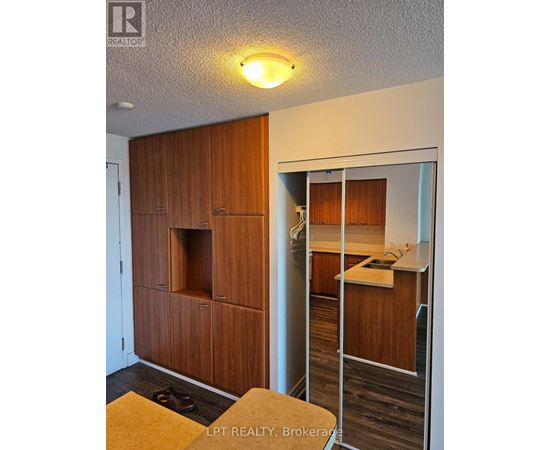 A wooden cabinet with a glass door is in the foreground.