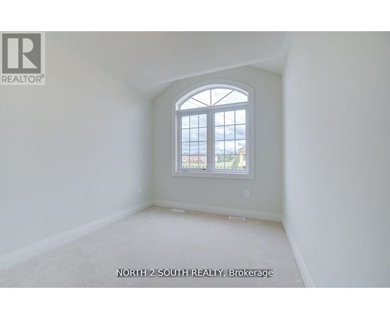 A room with a large window and a carpeted floor.