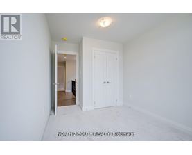 A white room with a door and a window.
