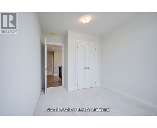 A white room with a door and a window.
