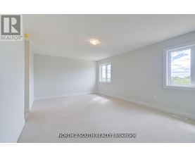 A spacious room with a window and a door, ready for a new tenant.