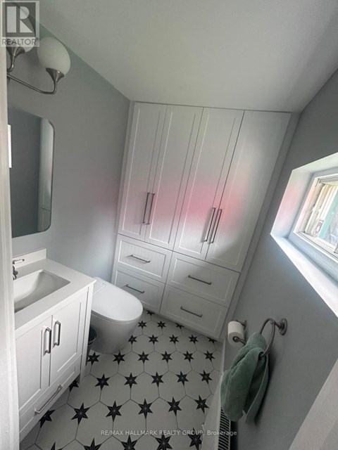 A bathroom with a black and white floor.