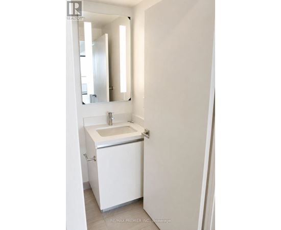 A white sink in a white bathroom.