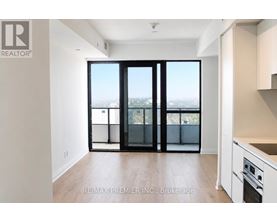 A spacious room with a view of the city through large windows.