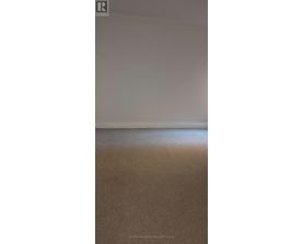 A plain white wall with a light switch on the right side.