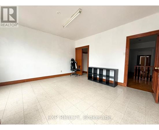 A room with white walls and a tiled floor.