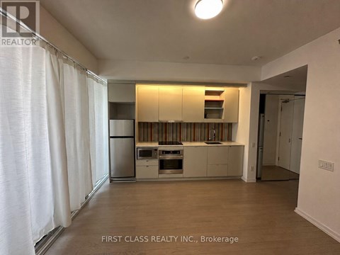 A kitchen with white cabinets and a dishwasher.