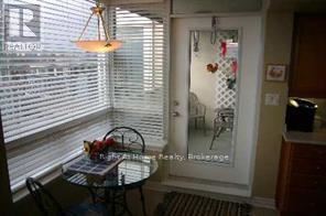 A dining room with a table and chairs.