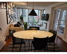 A modern dining room with a large table and chairs.