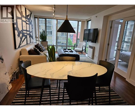 A modern dining room with a large table and chairs.