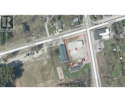 An aerial view of a property with a red outlined area and a blue pool in the middle.
