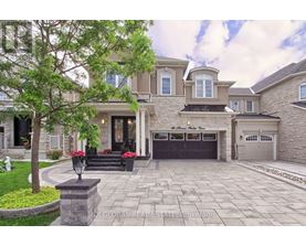 A large house with a stone walkway in front.
