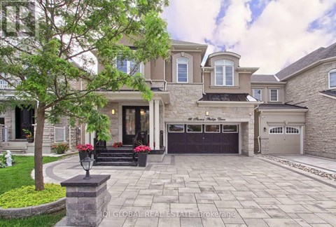A large house with a stone walkway in front.