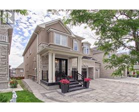 A house with a front yard and a stone pillar.