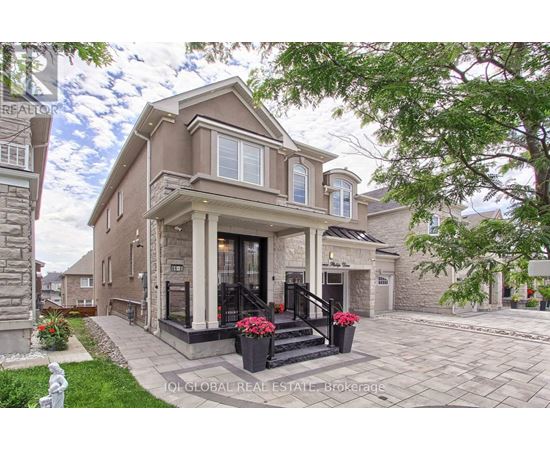 A house with a front yard and a stone pillar.
